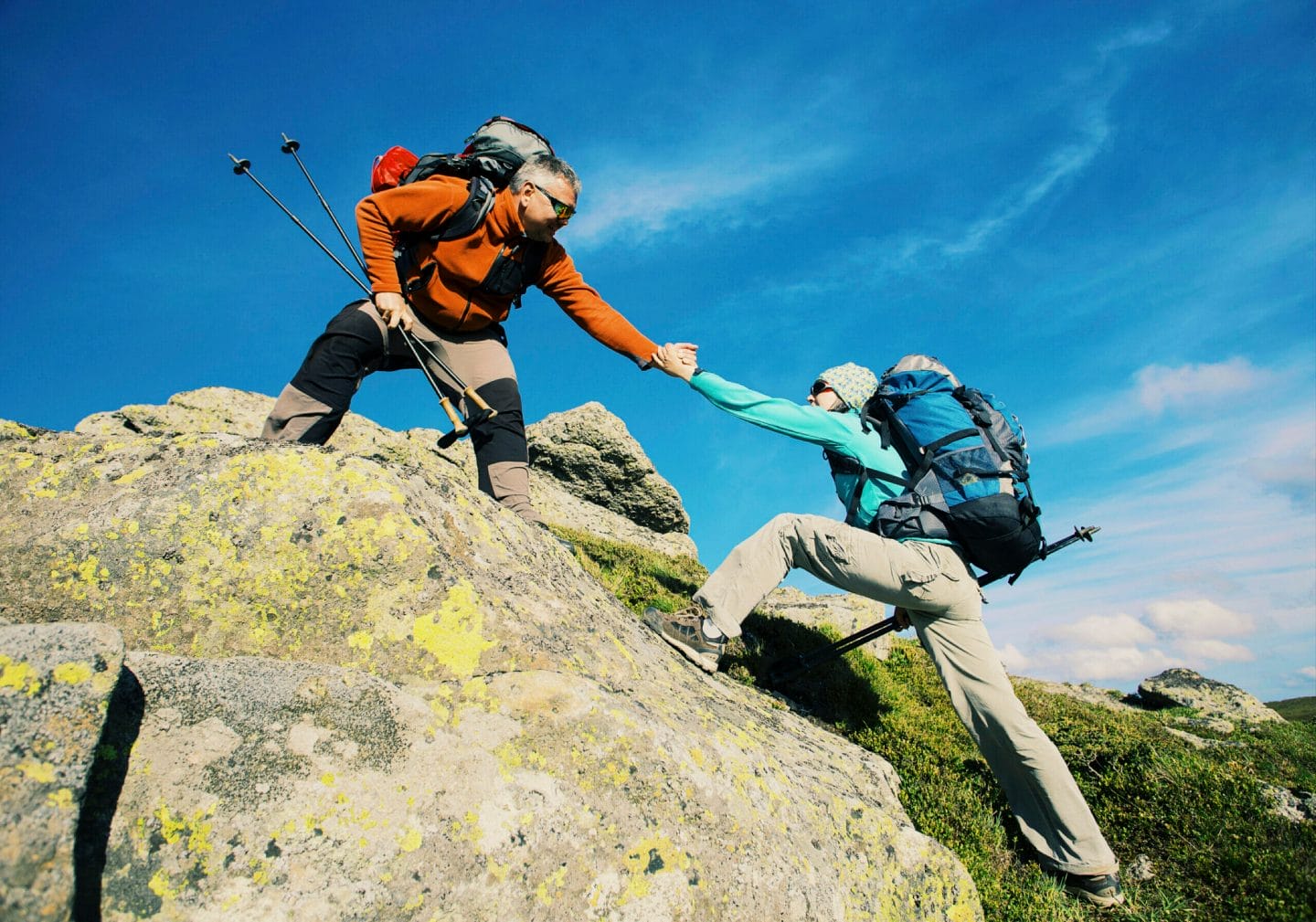 Couple Man and Woman help giving hands climbing rocky mountains Love and Travel Lifestyle concept hiking adventure vacations outdoor 903605010 5207x3648 scaled